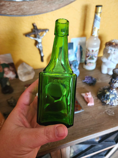 Vintage green glass bitters bottle