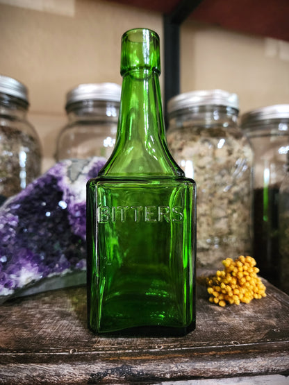 Vintage green glass bitters bottle